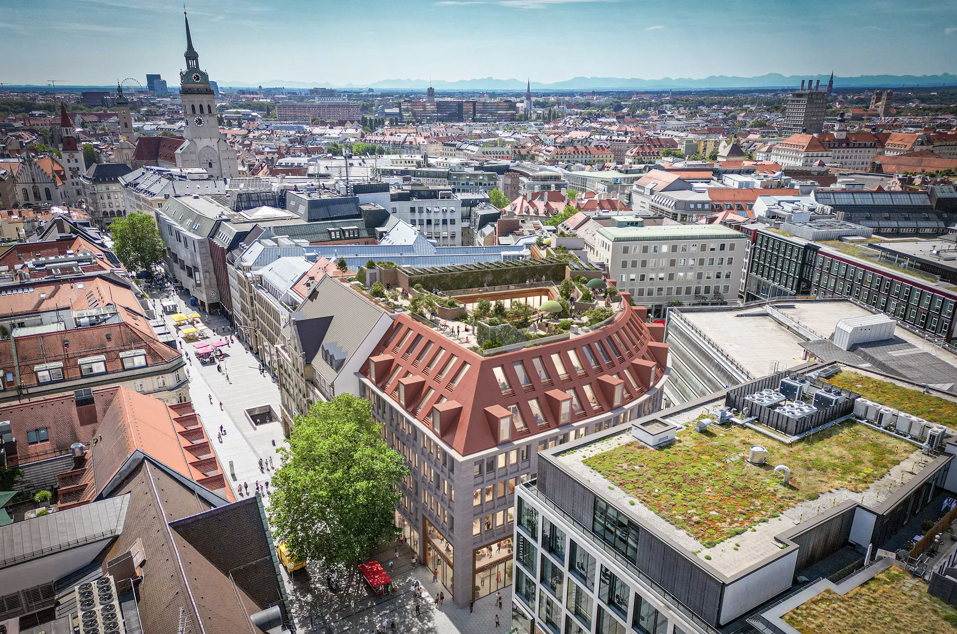 Luftaufnahme von München mit modernen Gebäuden und begrünten Dächern im Stadtzentrum bei sonnigem Wetter.