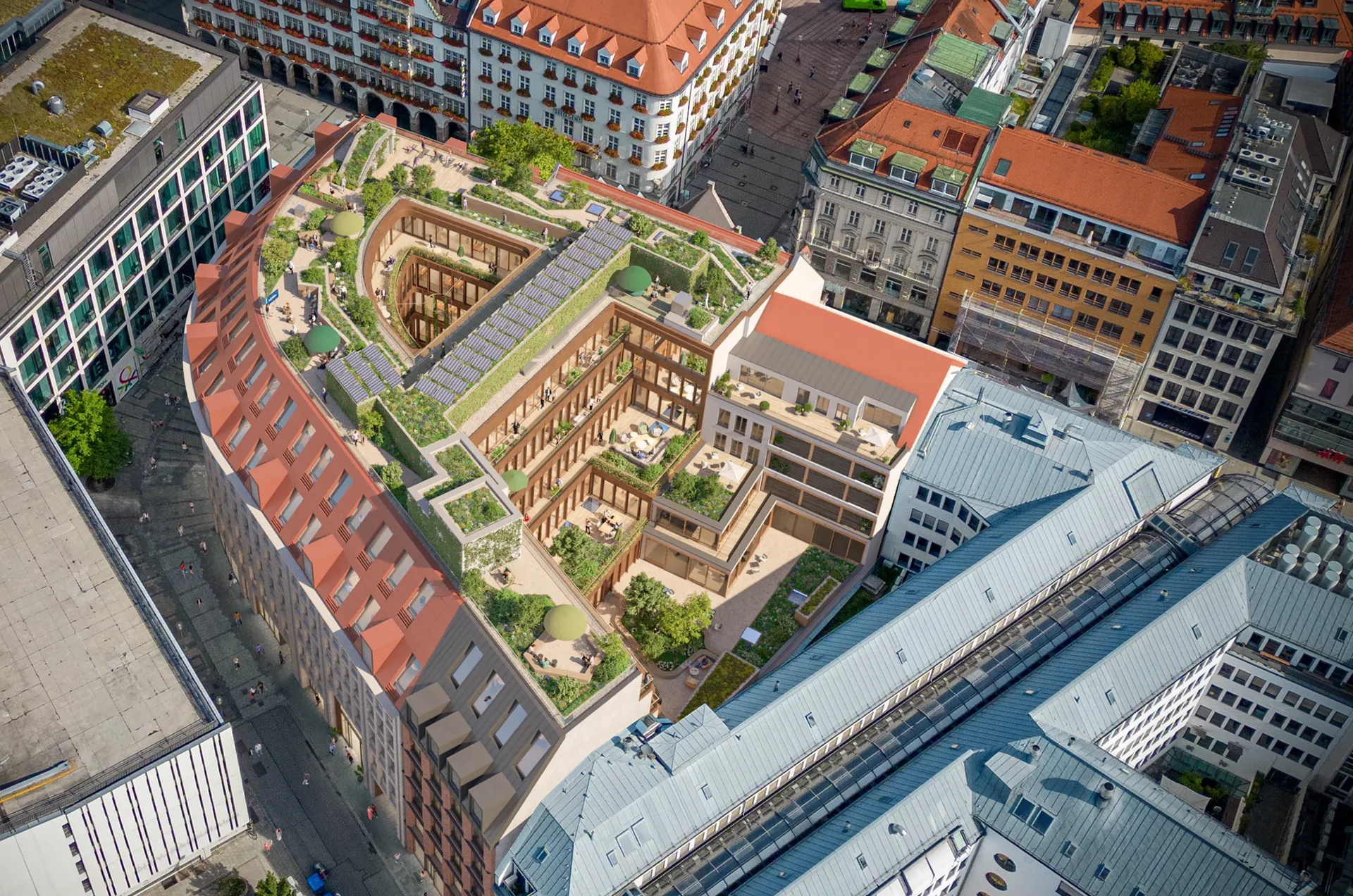 Luftaufnahme von einem modernen Gebäudekomplex mit begrünten Dachterrassen im Herzen von München.